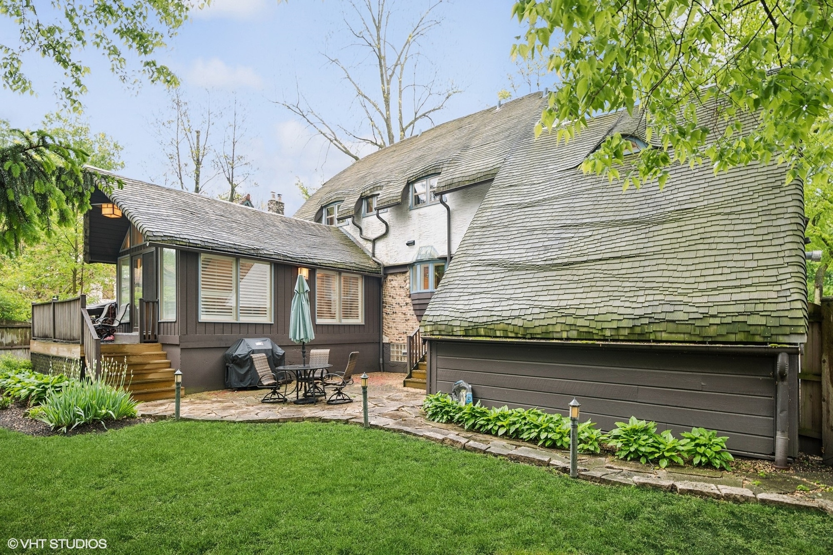 1487 Tower Road Winnetka, IL 60093 - Photo 38 of 45 a view of a backyard with plants and a patio