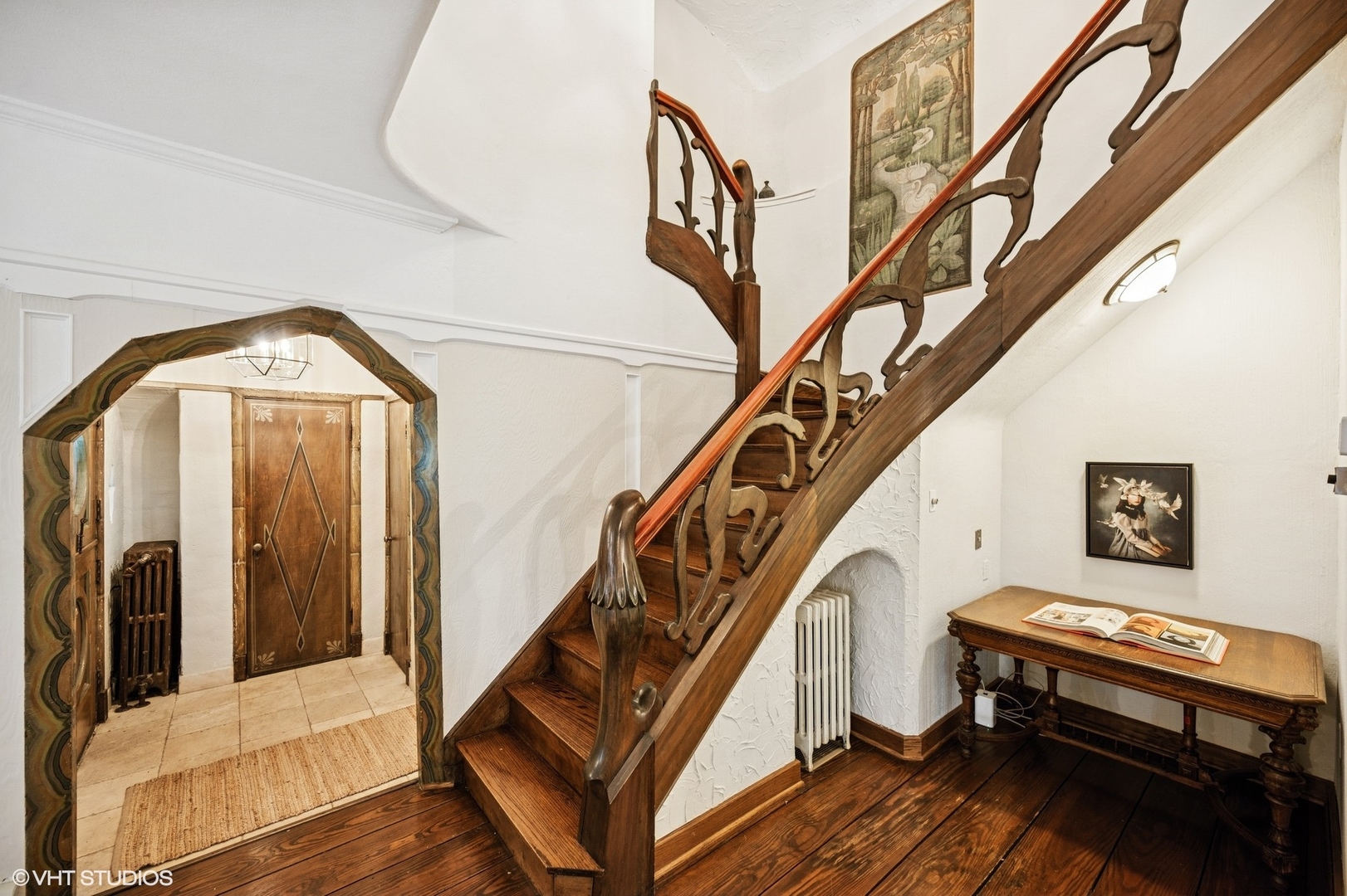 1487 Tower Road Winnetka, IL 60093 - Photo 6 of 45 a view of staircase with lots of frames and couch