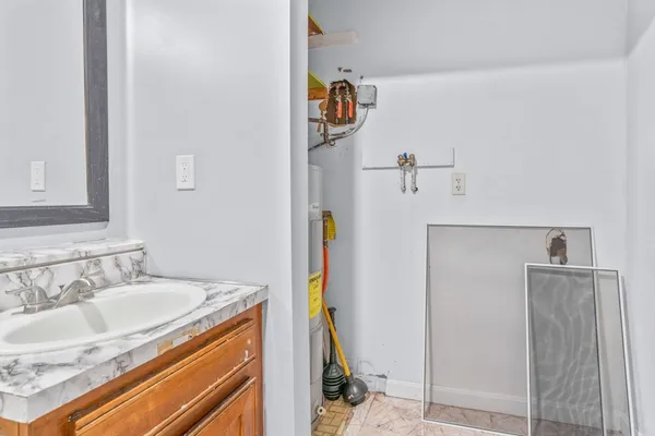 a bathroom with a sink vanity and shower