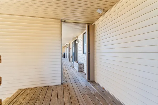 a view of a wooden deck besides a house