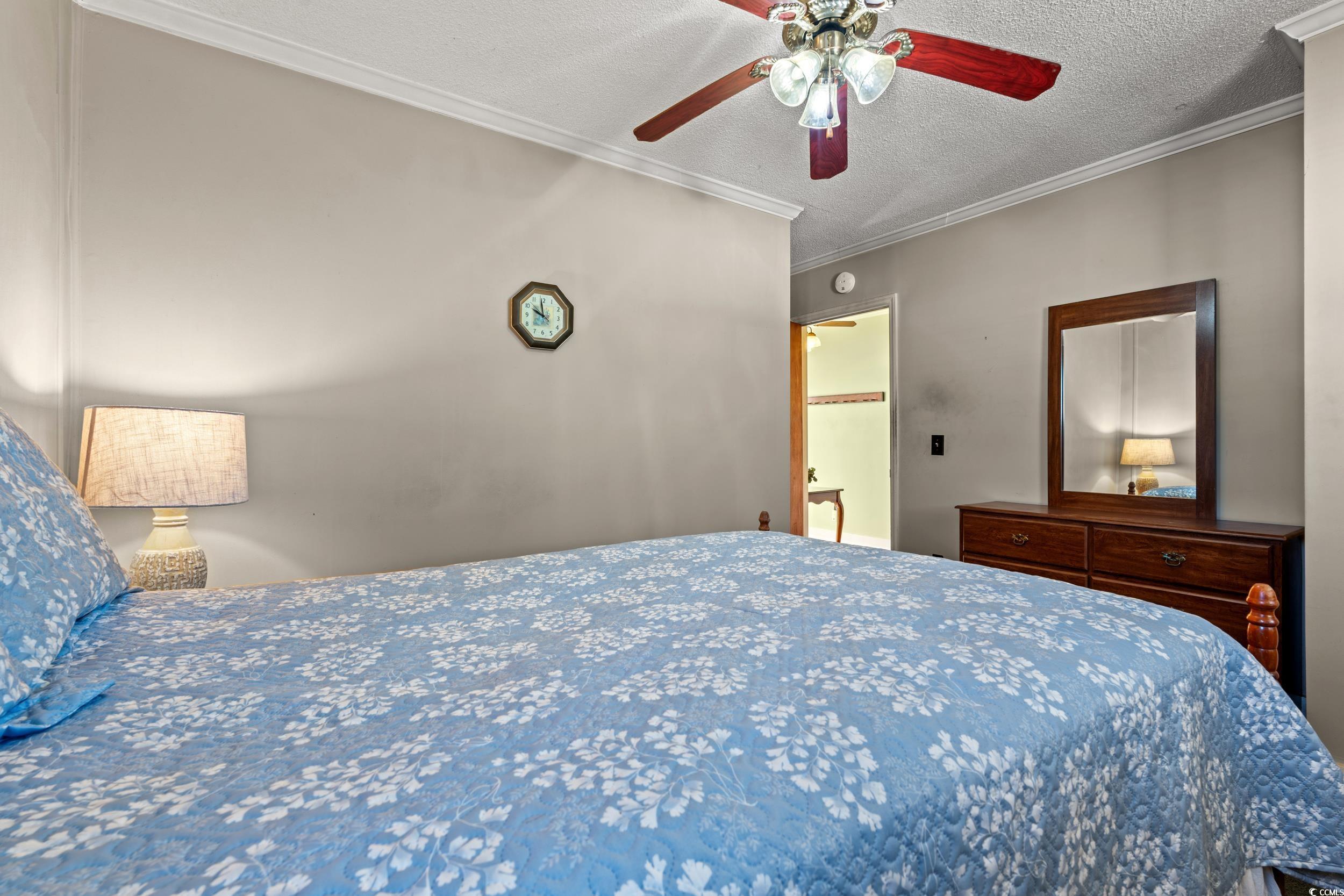1861 Jenerette Street Mullins, SC 29574 - Photo 14 of 36 Bedroom with a textured ceiling, ornamental molding, and a ceiling fan