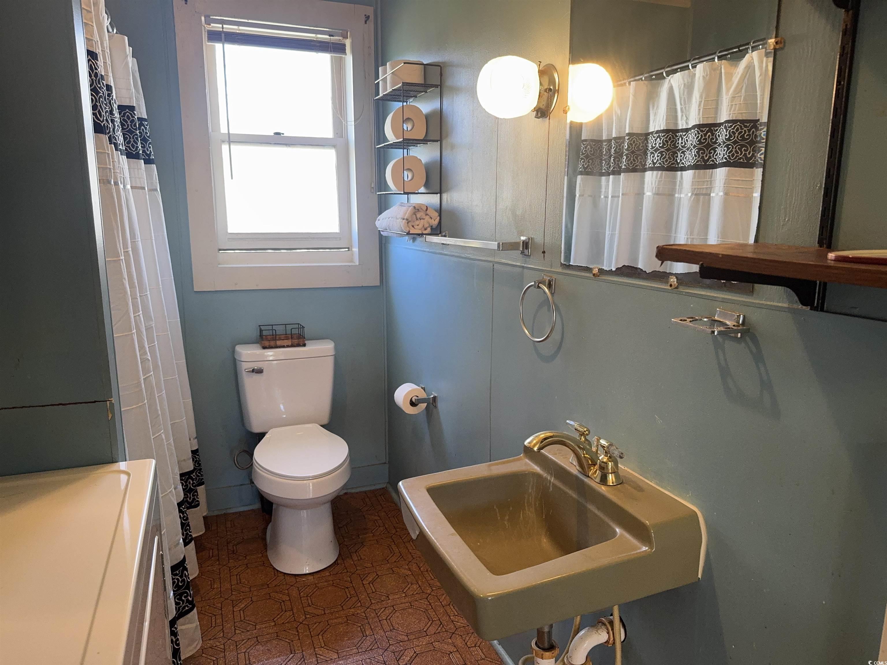 1861 Jenerette Street Mullins, SC 29574 - Photo 16 of 36 Bathroom with toilet, a shower with shower curtain, and a sink