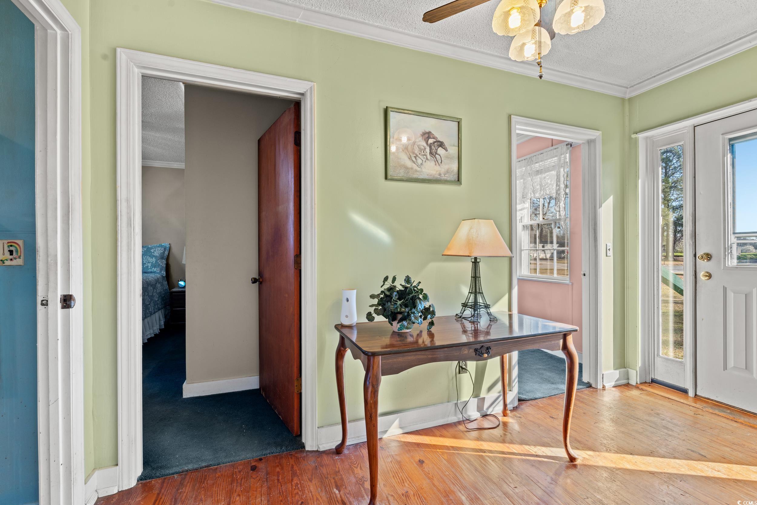 1861 Jenerette Street Mullins, SC 29574 - Photo 19 of 36 Foyer with a ceiling fan, wood finished floors, baseboards, ornamental molding, and a textured ceiling