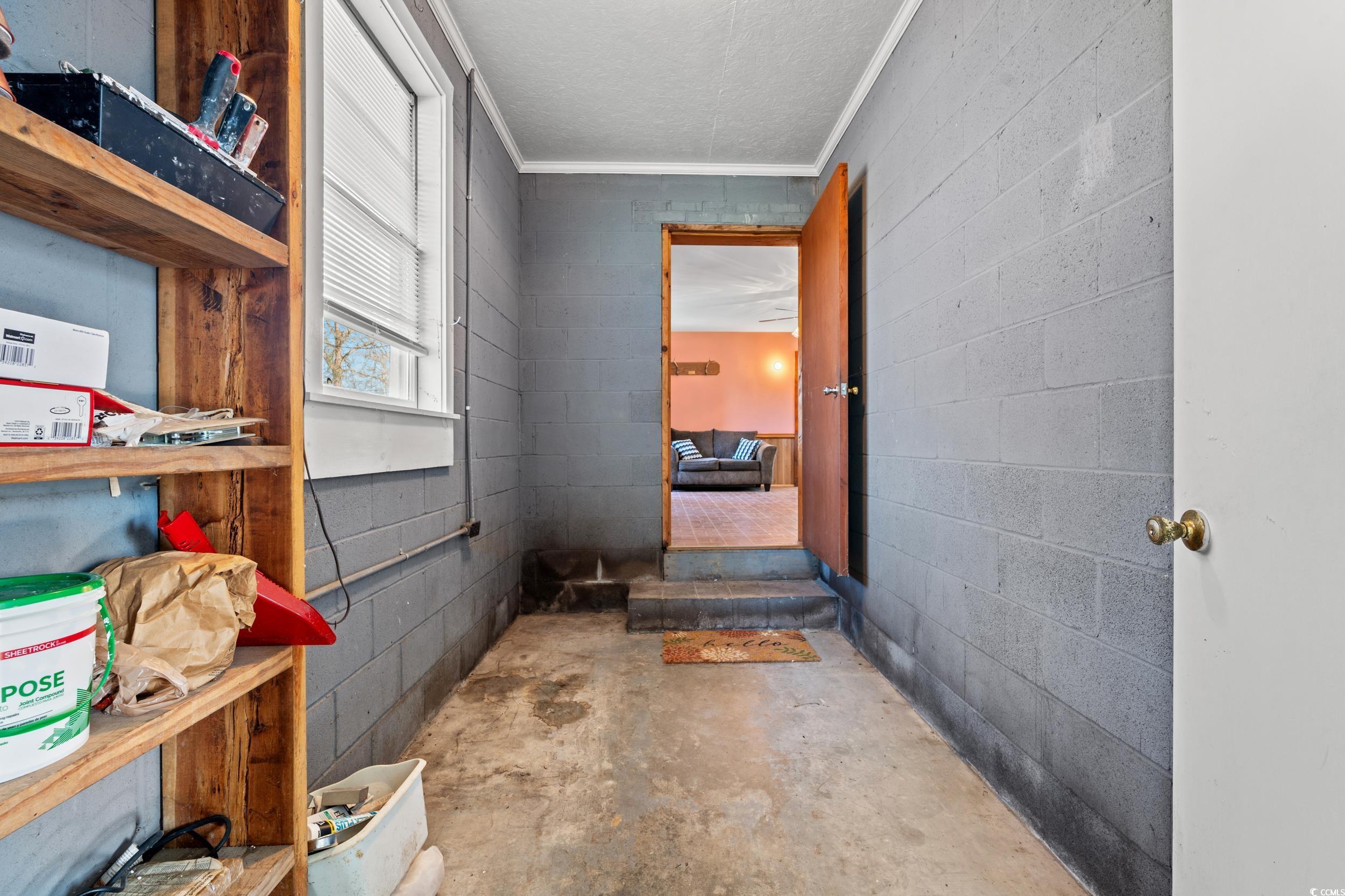 1861 Jenerette Street Mullins, SC 29574 - Photo 21 of 36 Interior space featuring concrete floors, concrete block wall, and crown molding