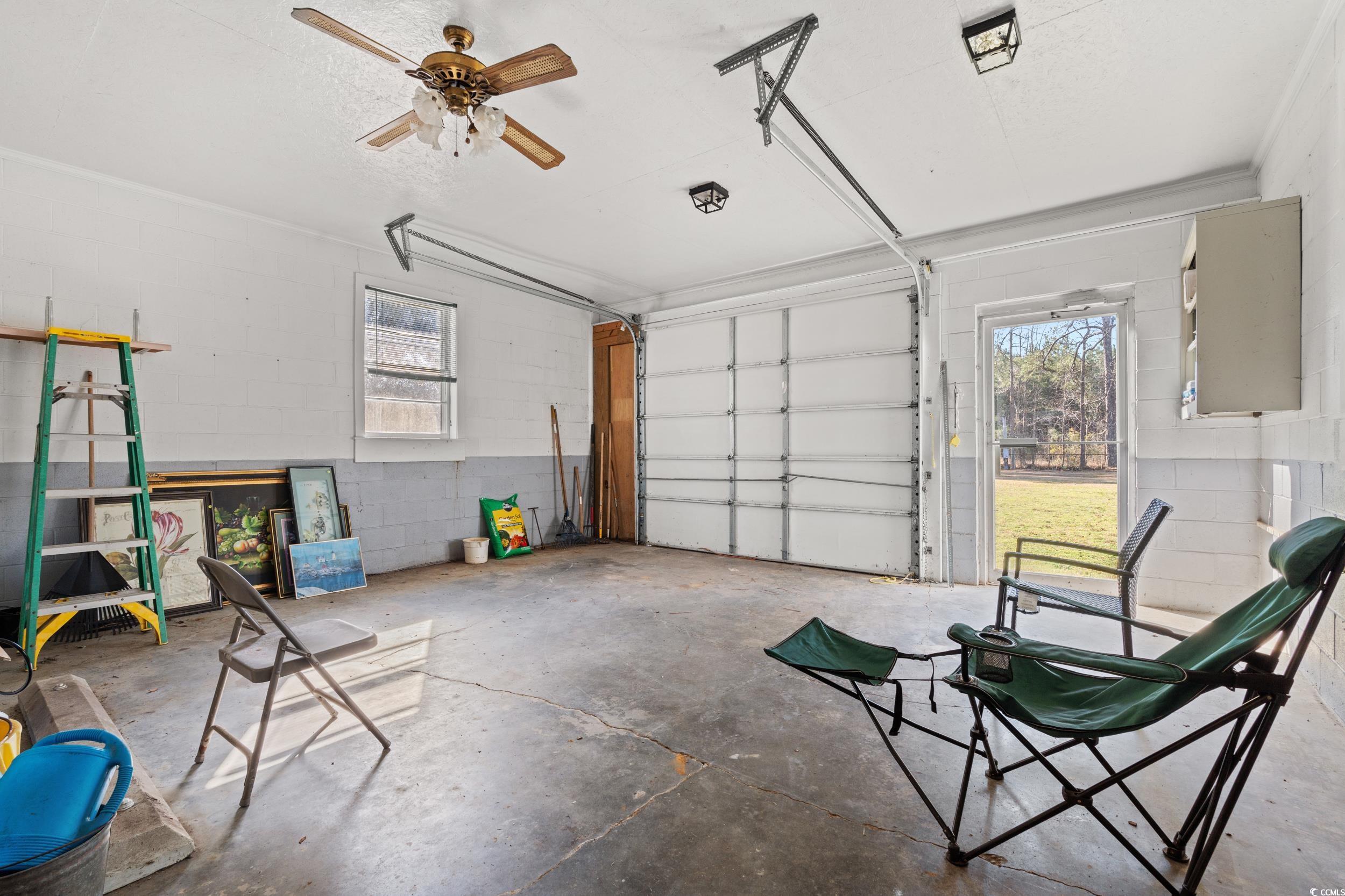 1861 Jenerette Street Mullins, SC 29574 - Photo 22 of 36 Garage featuring ceiling fan and concrete block wall