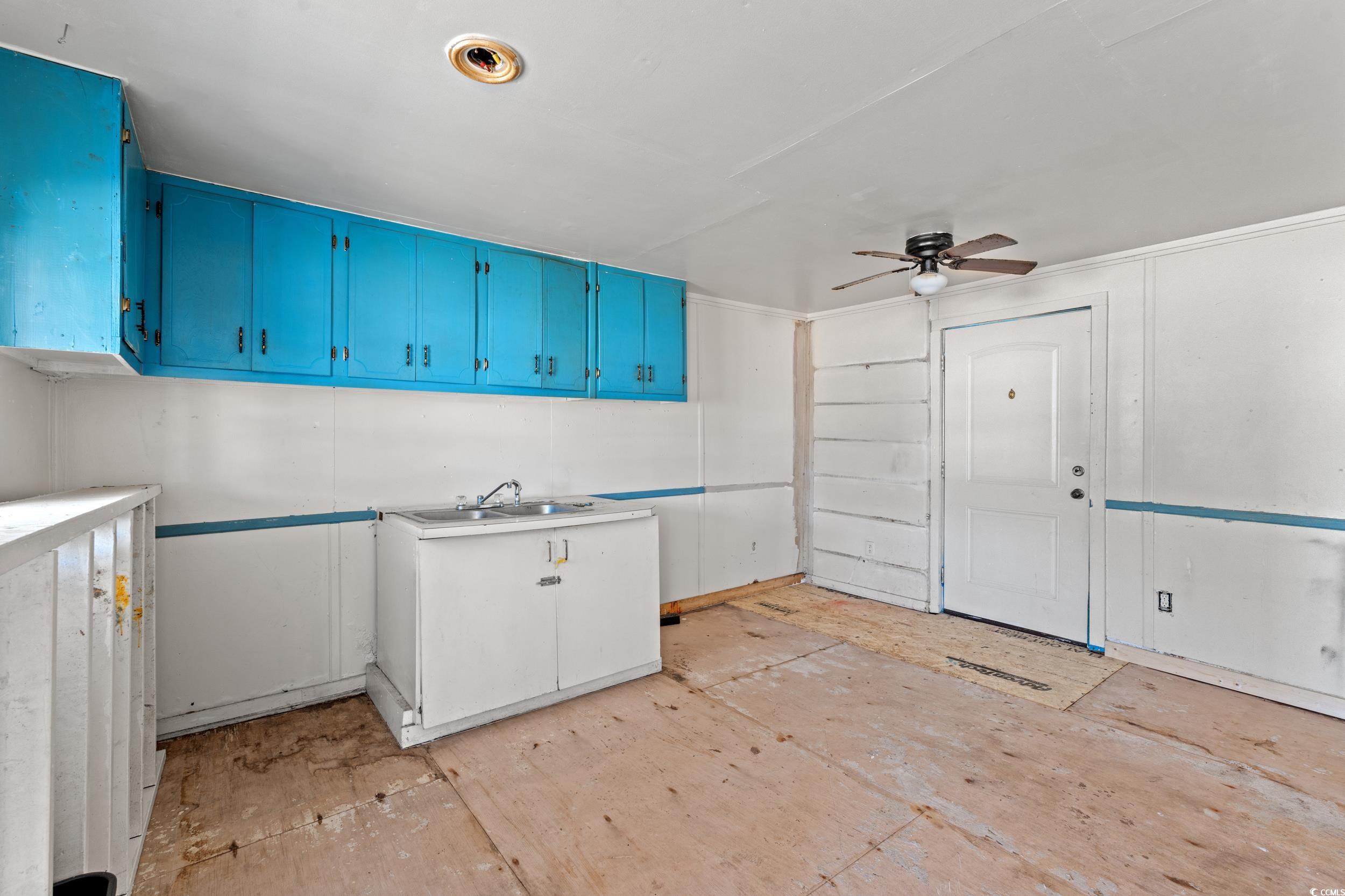 1861 Jenerette Street Mullins, SC 29574 - Photo 29 of 36 Kitchen with blue cabinetry, a ceiling fan, and a sink