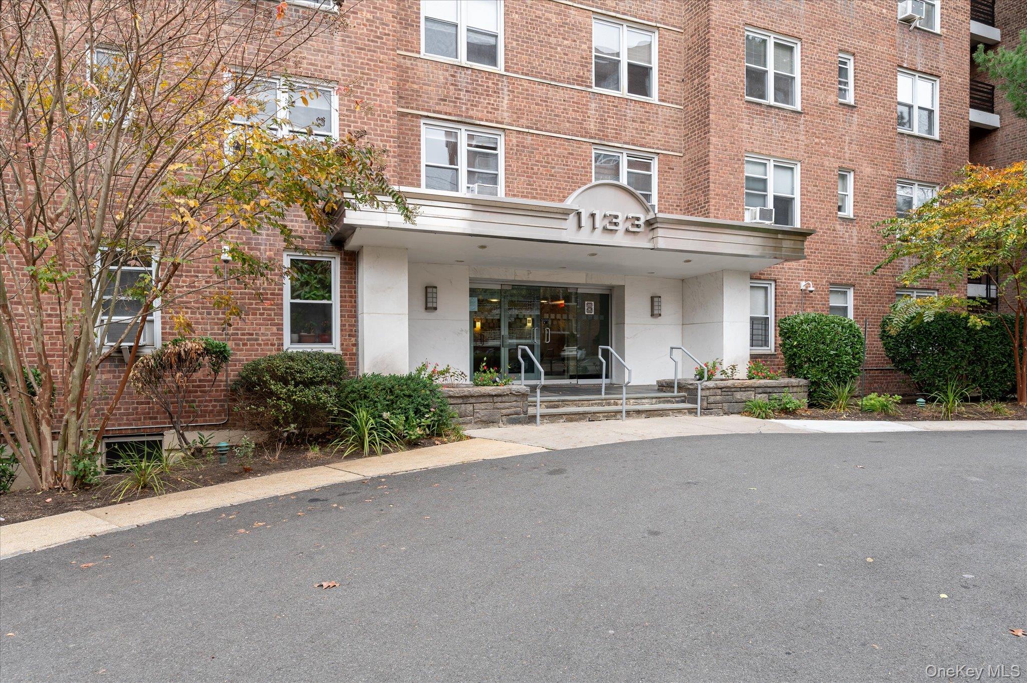 1133 Midland Avenue, Unit 4C Bronxville, NY 10708 - Photo 25 of 30 a view of a building with a yard