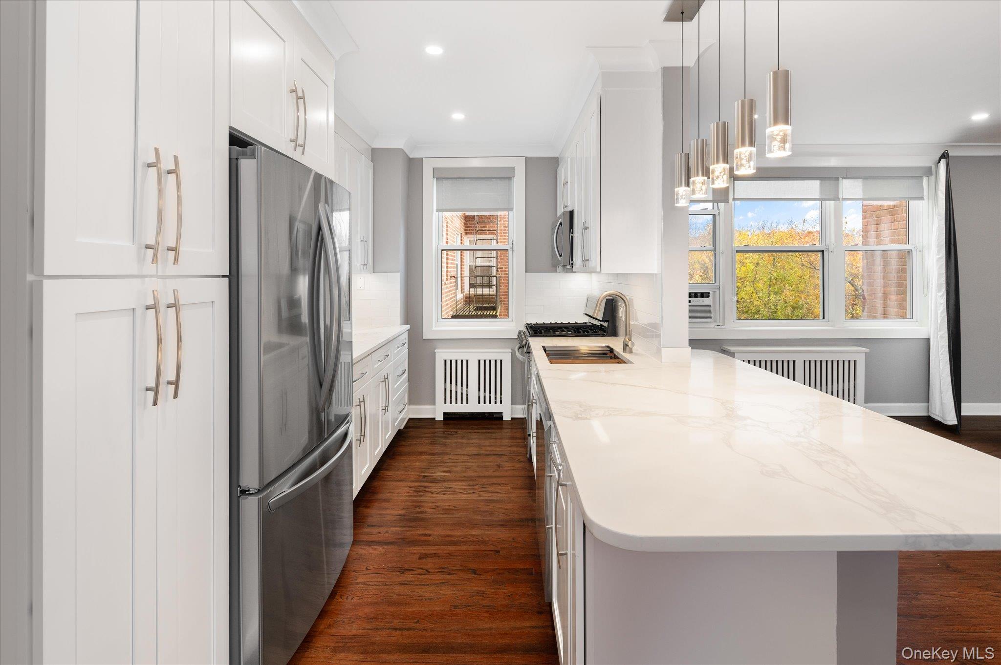1133 Midland Avenue, Unit 4C Bronxville, NY 10708 - Photo 5 of 30 a kitchen with stainless steel appliances a refrigerator sink and cabinets