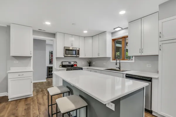 a kitchen with a sink a stove and cabinets
