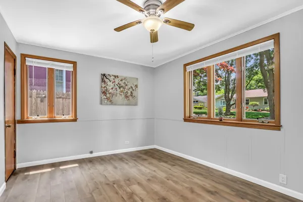 a view of empty room with window and wooden floor