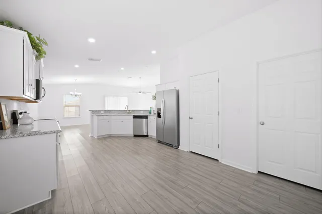 a large kitchen with a lot of counter space stainless steel appliances and cabinets