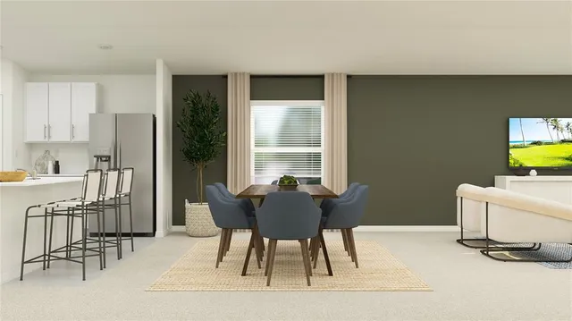 a view of a dining room with furniture and a window