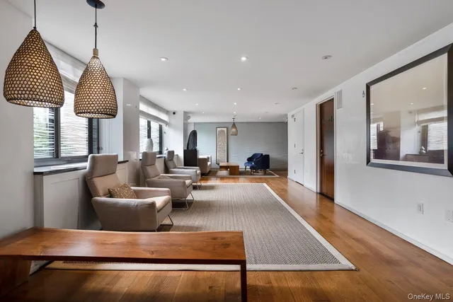 a living room with furniture a window and a chandelier