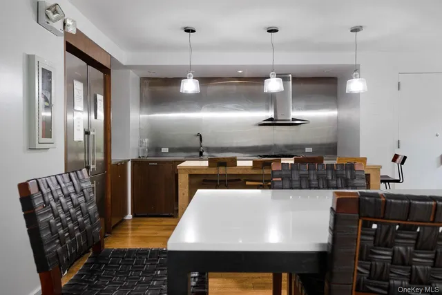 a kitchen with stainless steel appliances granite countertop a sink a stove and a refrigerator