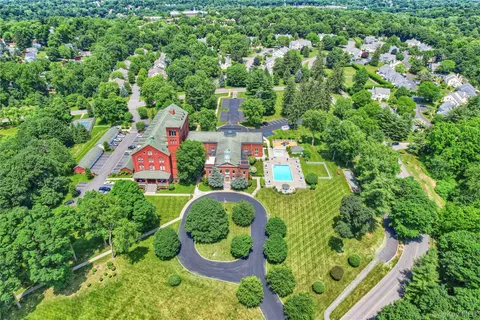 an aerial view of residential house with outdoor space and swimming pool