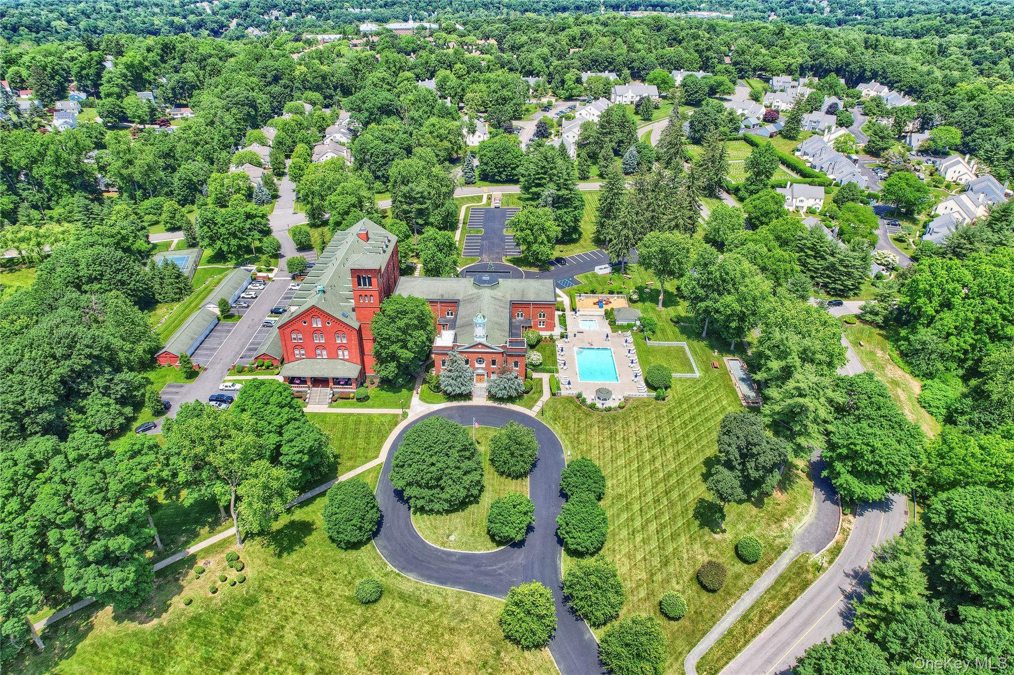 an aerial view of residential house with outdoor space and swimming pool