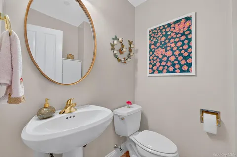 a bathroom with a sink mirror and toilet