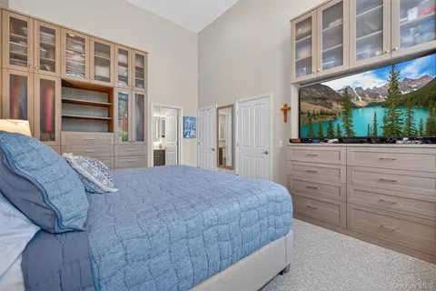 a bedroom with a bed and a large window