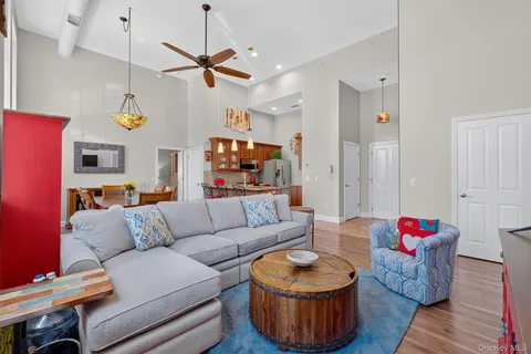 a living room with furniture and a chandelier