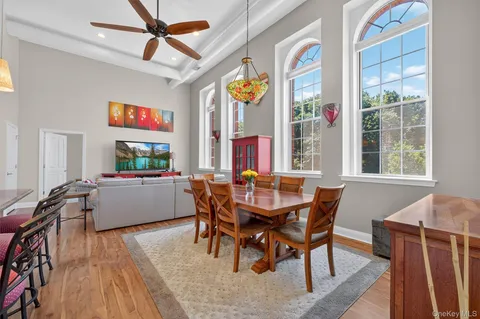 a dining room with furniture a chandelier and wooden floor
