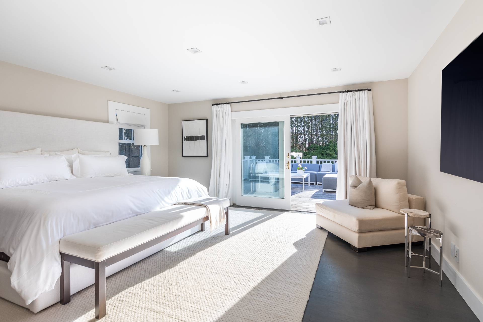 Undisclosed Address Bridgehampton, NY 11932 - Photo 11 of 22 a spacious bedroom with a bed couch and a flat tv screen