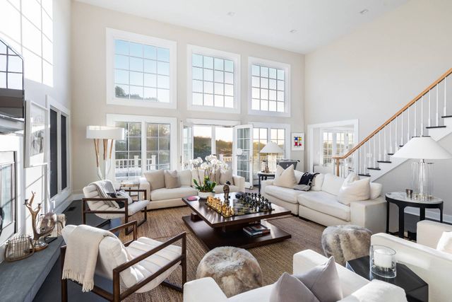 a kitchen with stainless steel appliances kitchen island granite countertop a stove and a large window