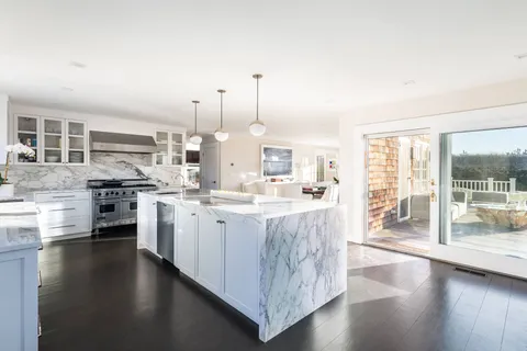 a living room with furniture a wooden floor and next to a window