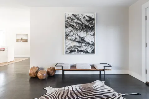 a bedroom with a bed and glass window