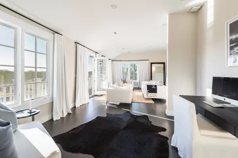 a bathroom with a granite countertop sink a window and shower