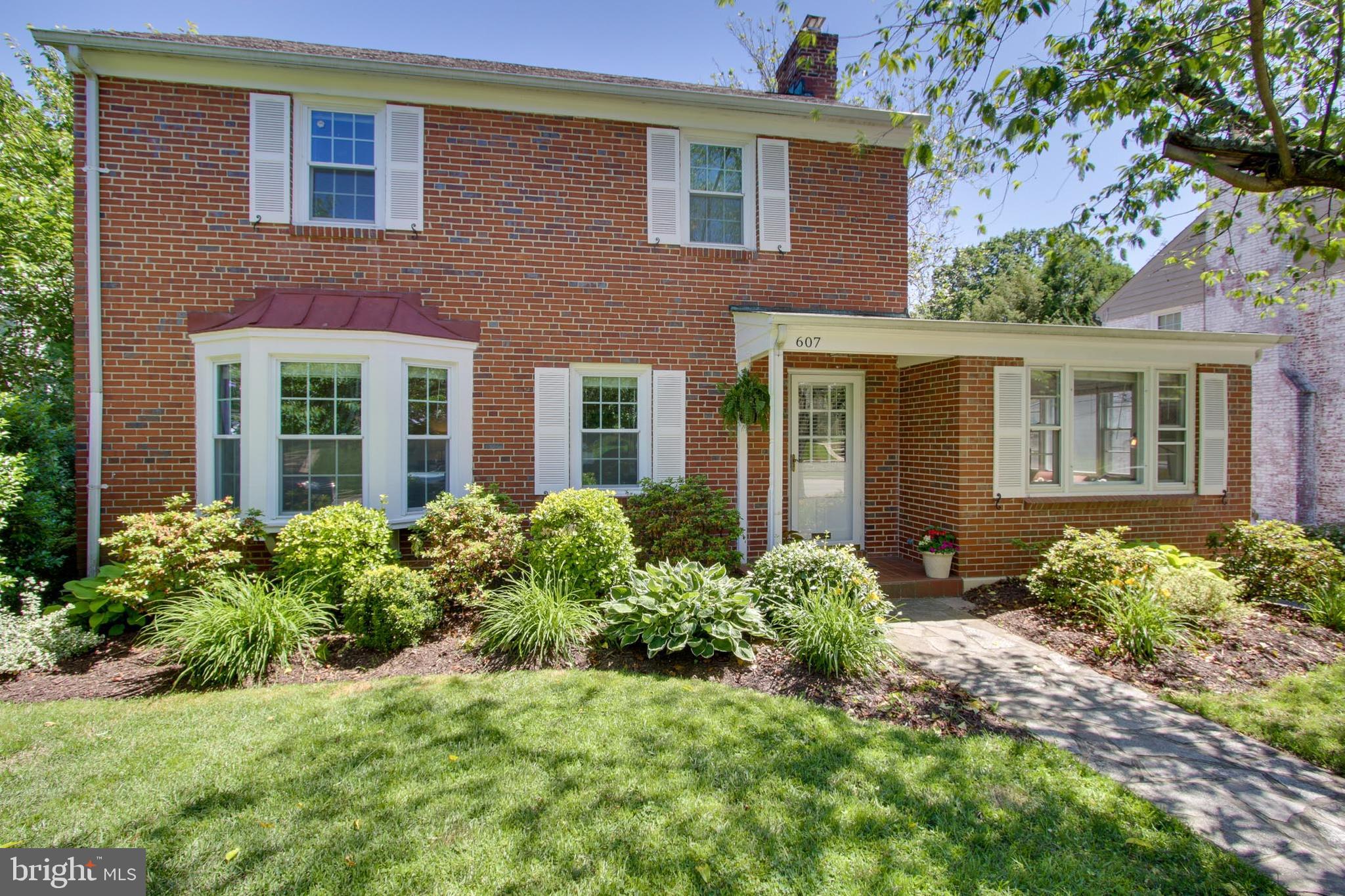 607 Worcester Road Baltimore, MD 21286 - Photo 1 of 42 front view of a brick house with a yard