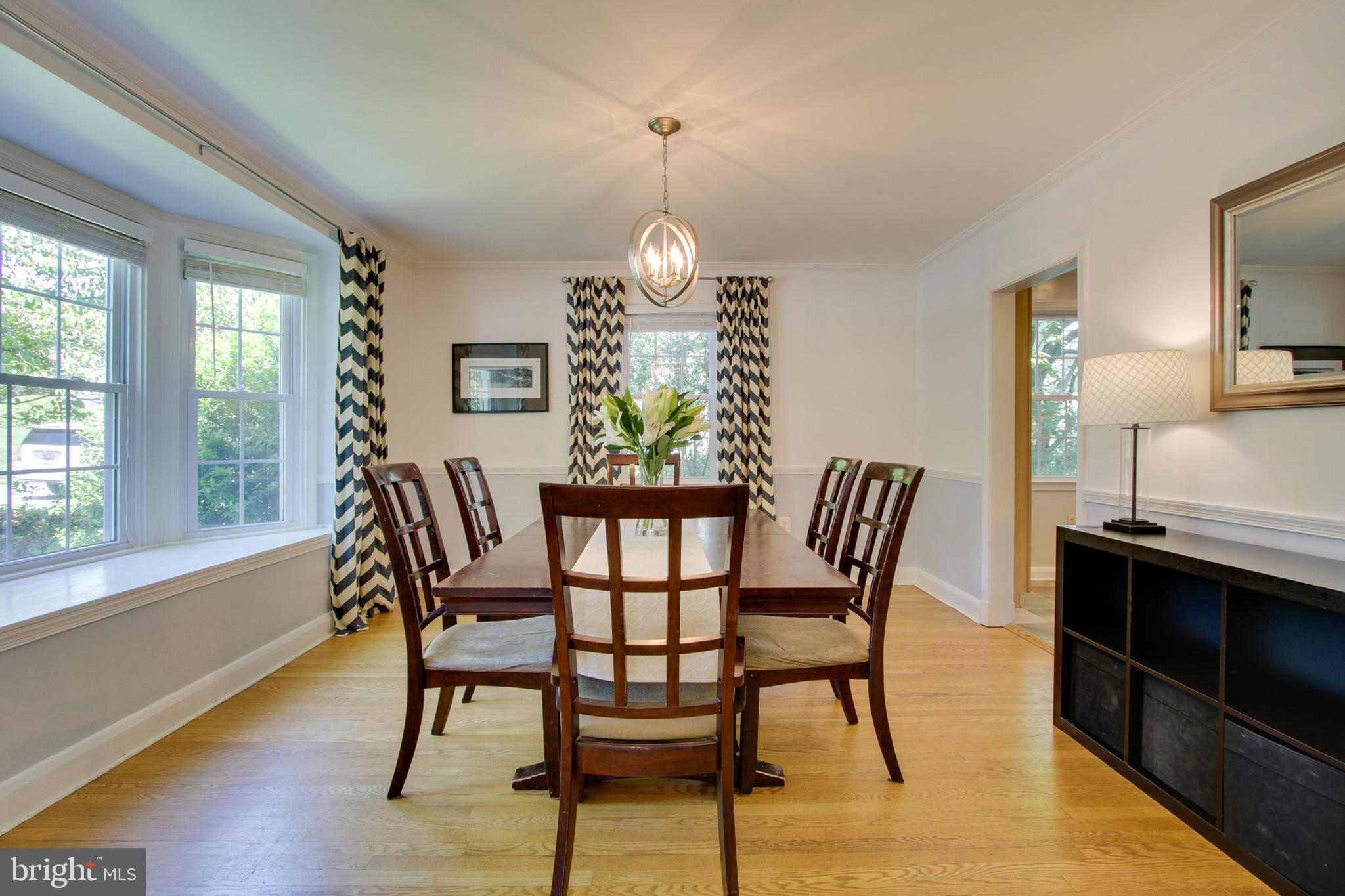 607 Worcester Road Baltimore, MD 21286 - Photo 13 of 42 a dining room with furniture a chandelier and wooden floor