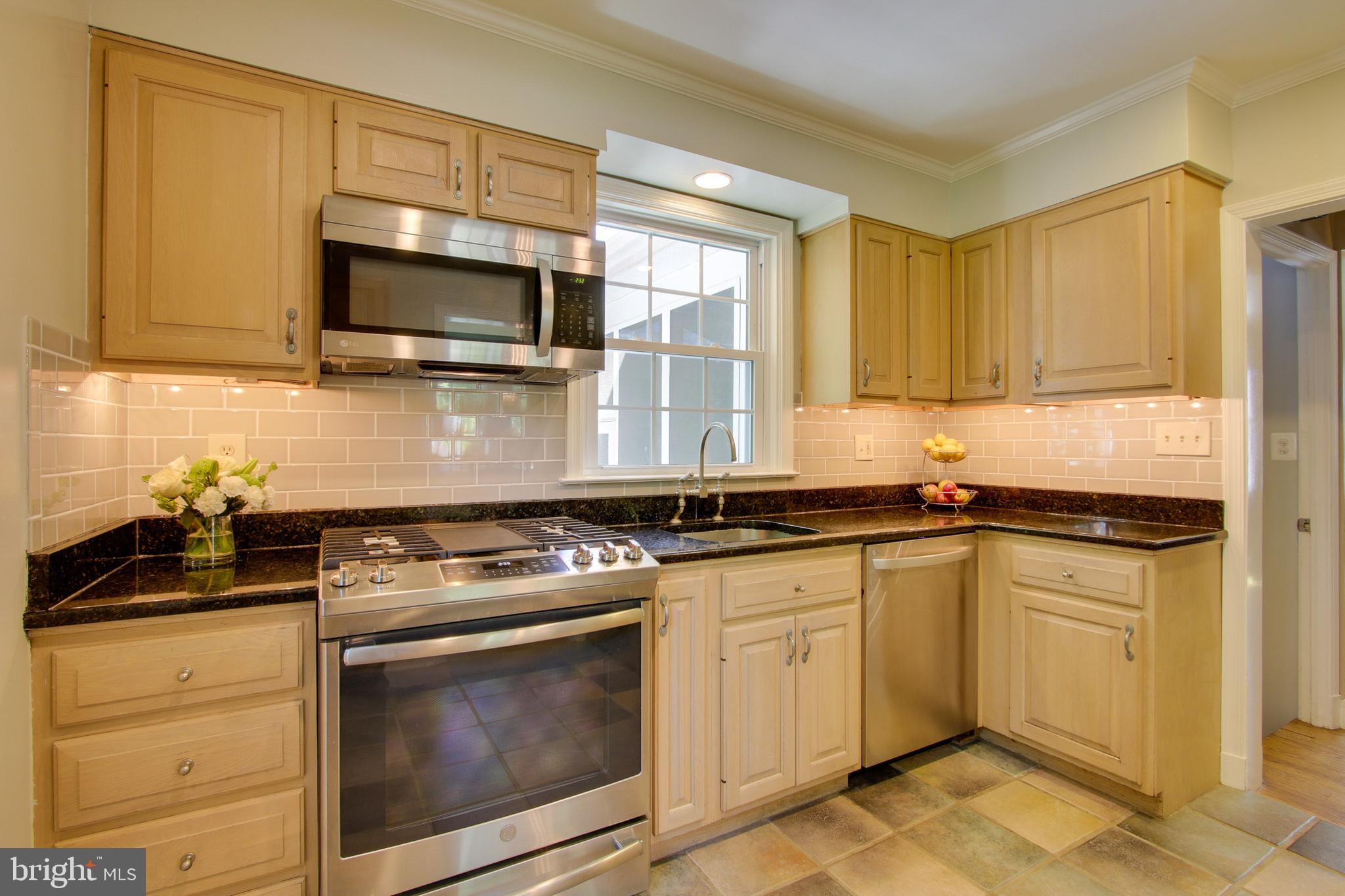 607 Worcester Road Baltimore, MD 21286 - Photo 16 of 42 a kitchen with stainless steel appliances granite countertop a stove microwave and sink