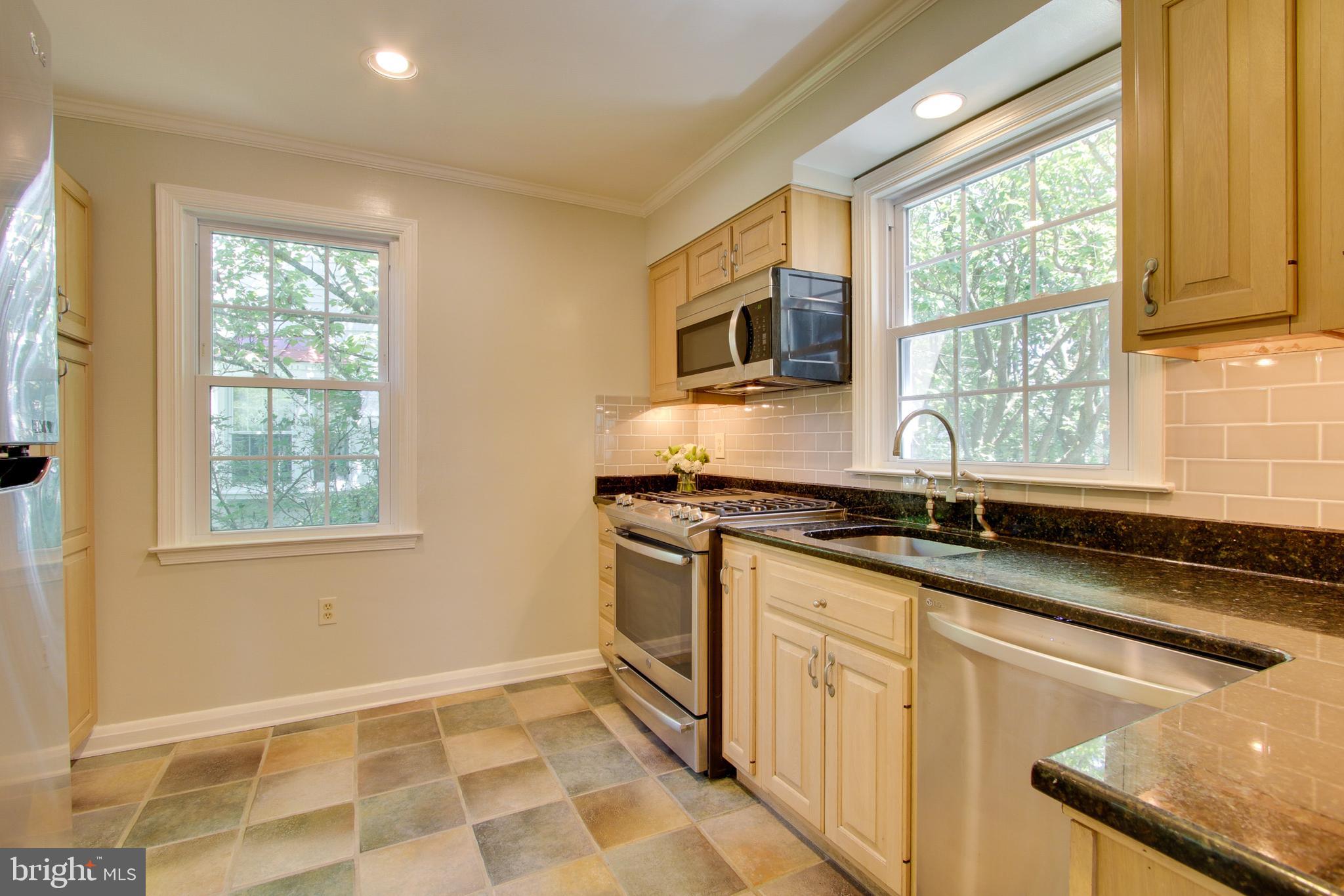 607 Worcester Road Baltimore, MD 21286 - Photo 18 of 42 a kitchen with granite countertop a sink appliances cabinets and a window