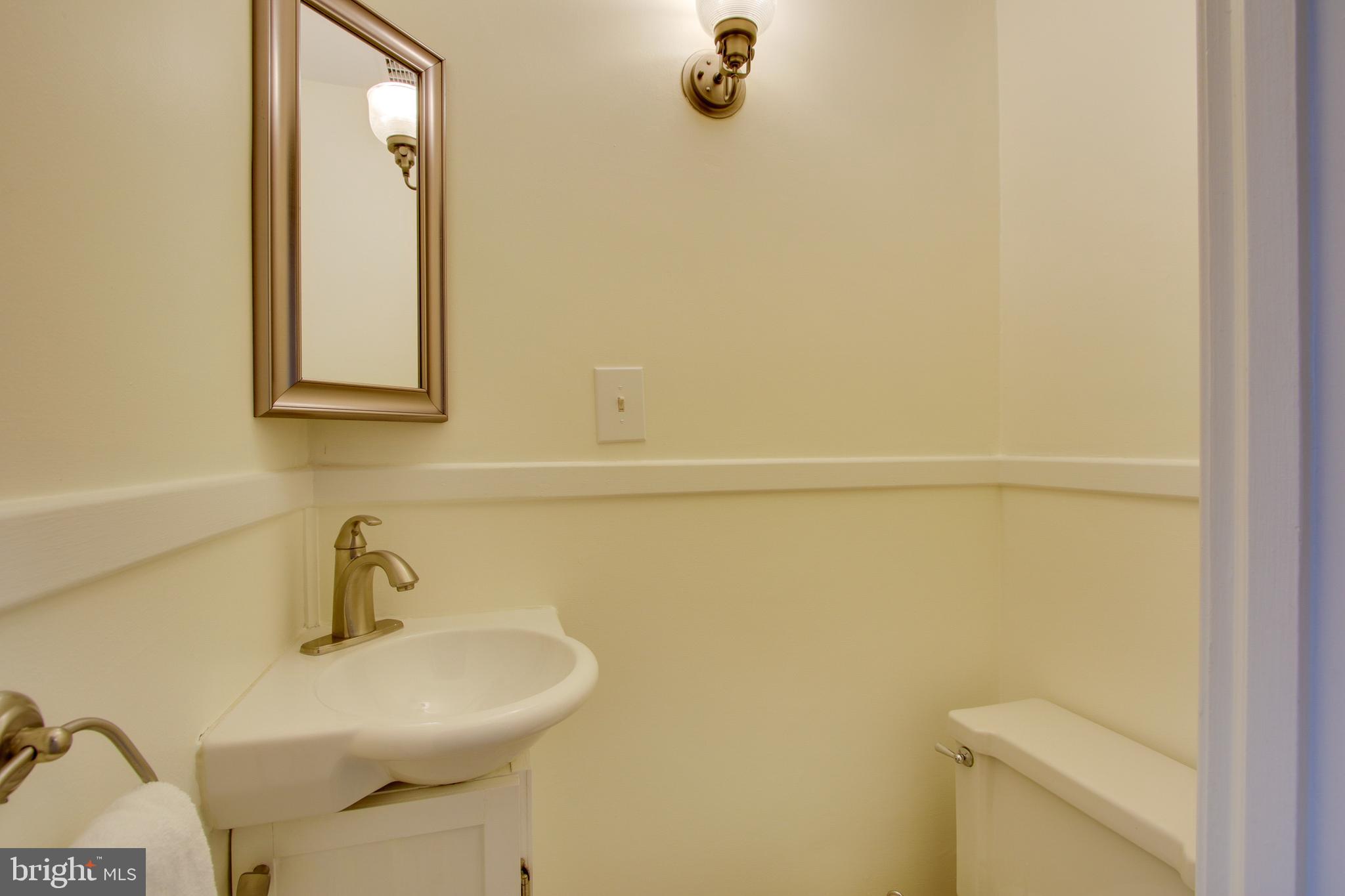 607 Worcester Road Baltimore, MD 21286 - Photo 20 of 42 a bathroom with a sink a toilet and mirror