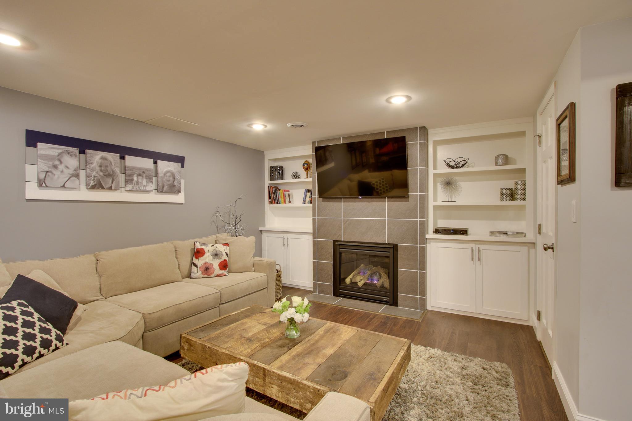 607 Worcester Road Baltimore, MD 21286 - Photo 25 of 42 a living room with furniture and a fireplace