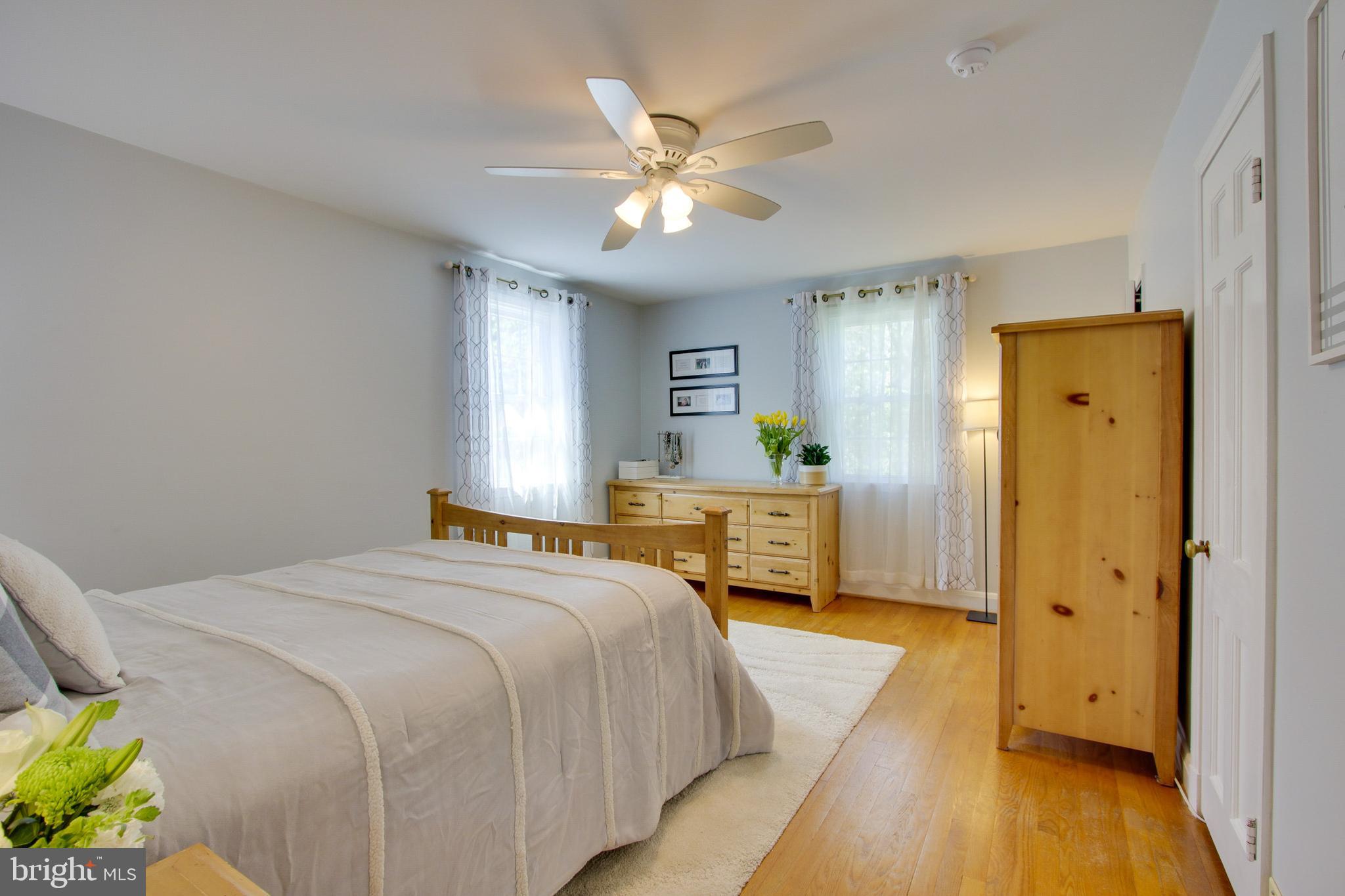 607 Worcester Road Baltimore, MD 21286 - Photo 31 of 42 a spacious bedroom with a bed and a chandelier