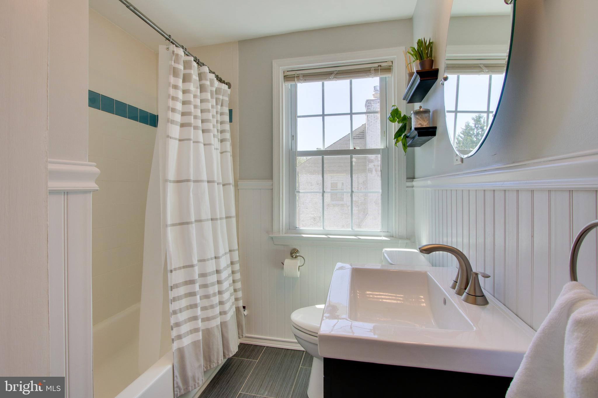 607 Worcester Road Baltimore, MD 21286 - Photo 35 of 42 a bathroom with a sink a mirror and a window