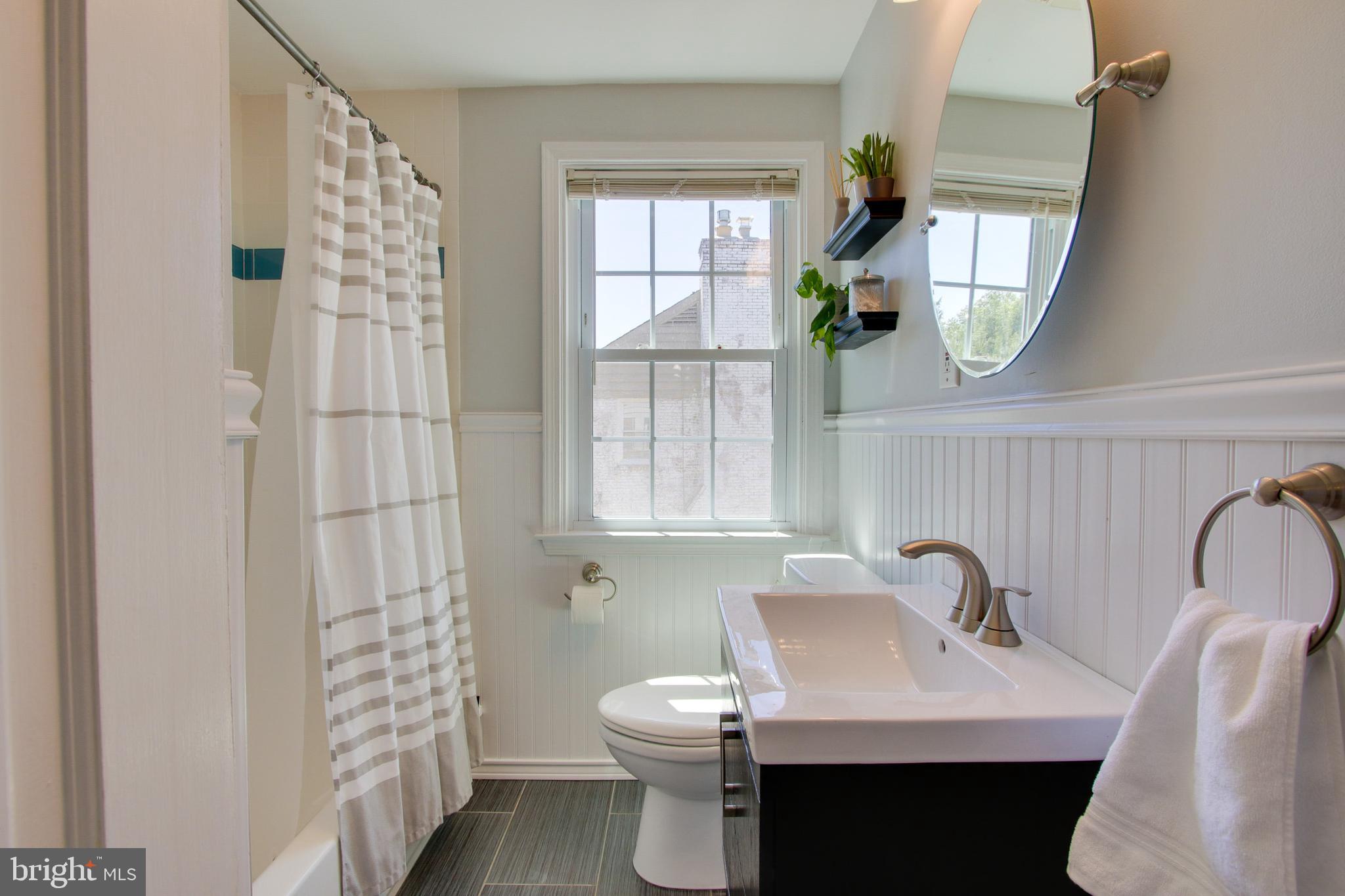 607 Worcester Road Baltimore, MD 21286 - Photo 36 of 42 a bathroom with a toilet a sink and a window