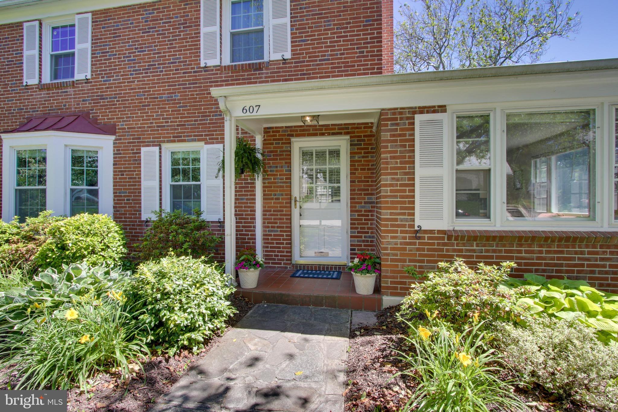 607 Worcester Road Baltimore, MD 21286 - Photo 5 of 42 front view of a brick house with potted plants