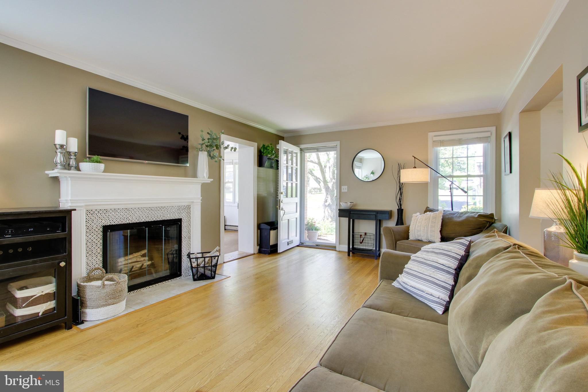 607 Worcester Road Baltimore, MD 21286 - Photo 9 of 42 a living room with furniture a fireplace and a flat screen tv