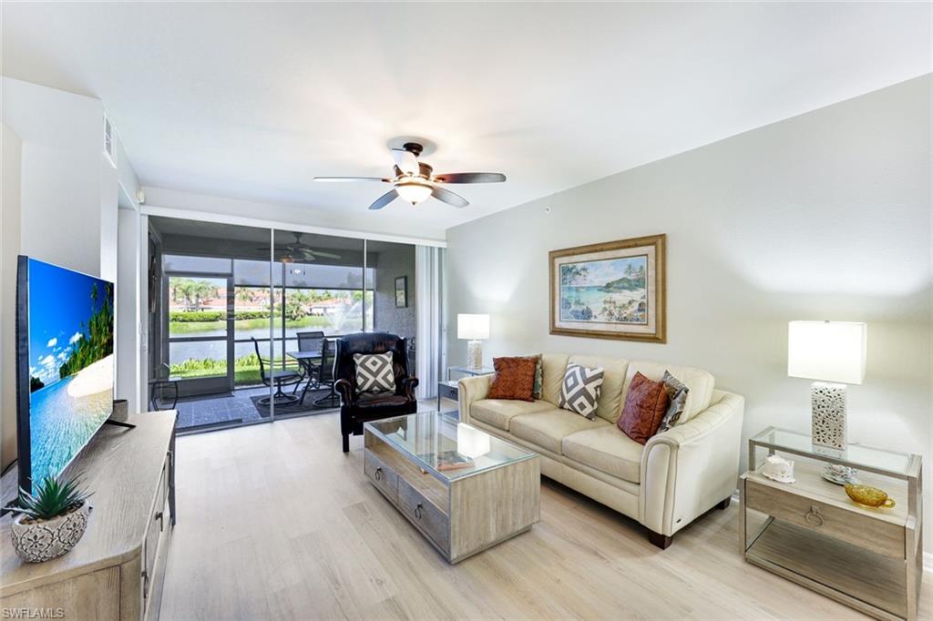 23861 Costa Del Sol Road, Unit 103 Estero, FL 34135 - Photo 1 of 29 a living room with furniture and a flat screen tv