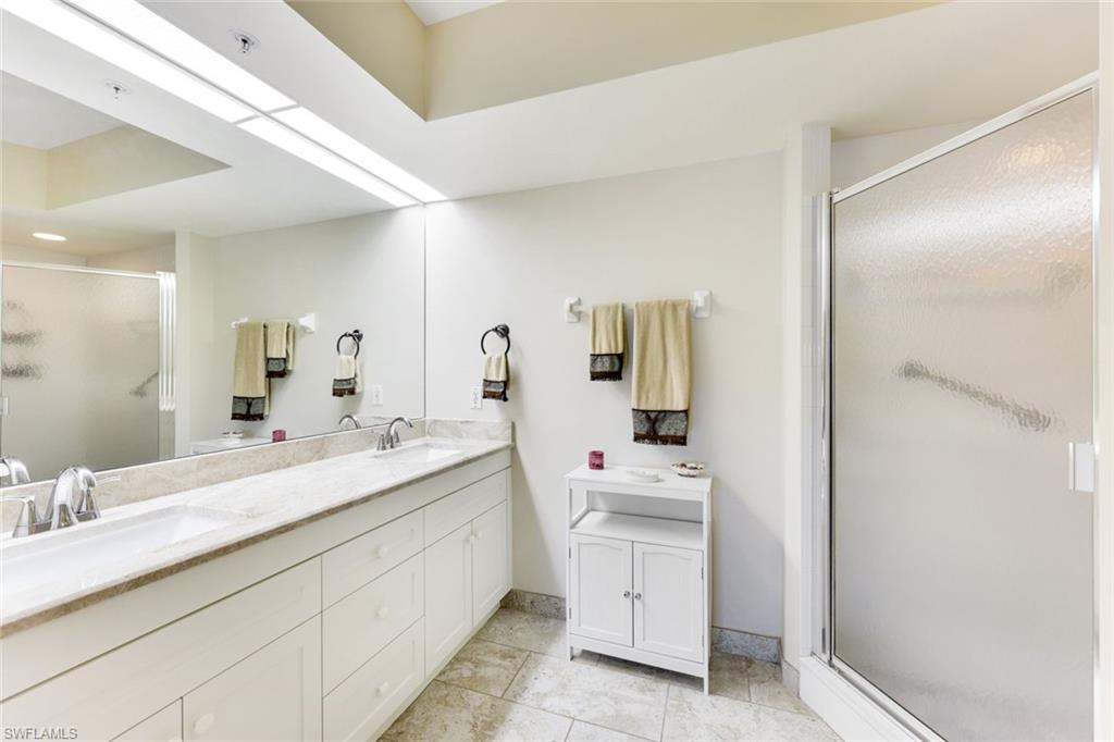 23861 Costa Del Sol Road, Unit 103 Estero, FL 34135 - Photo 11 of 29 a en suite bathroom with double sink and a mirror