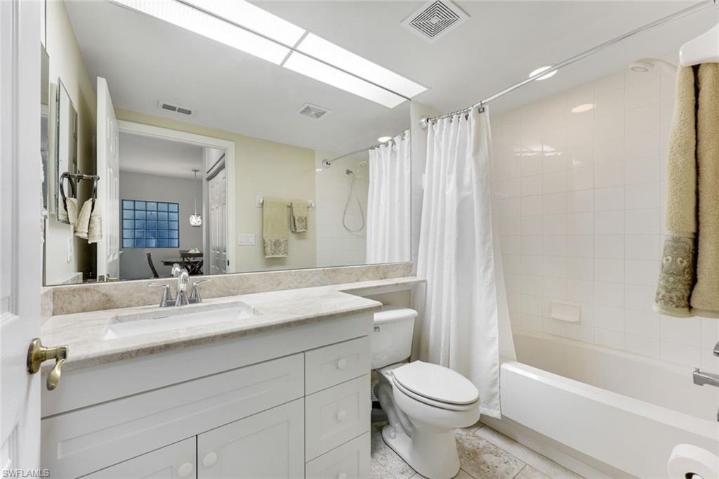 23861 Costa Del Sol Road, Unit 103 Estero, FL 34135 - Photo 13 of 29 a bathroom with a sink a toilet and shower