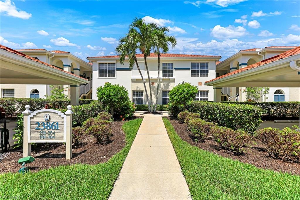 23861 Costa Del Sol Road, Unit 103 Estero, FL 34135 - Photo 16 of 29 a front view of a house with garden