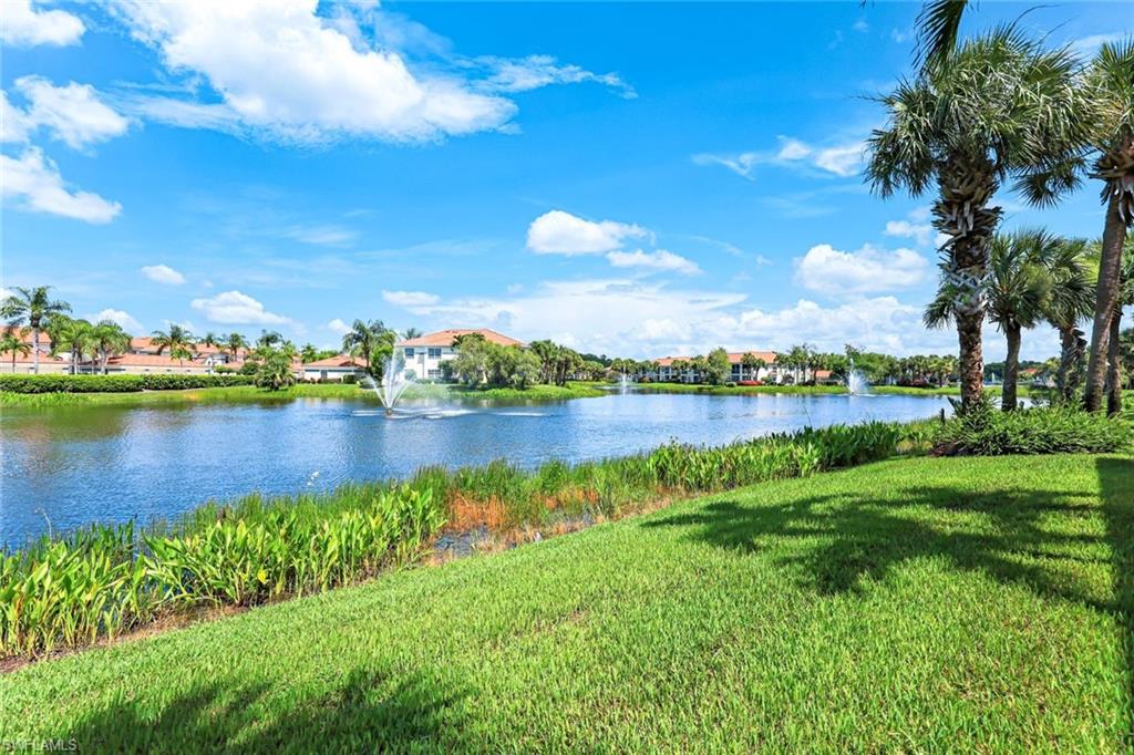 23861 Costa Del Sol Road, Unit 103 Estero, FL 34135 - Photo 29 of 29 a view of a lake with houses in the back