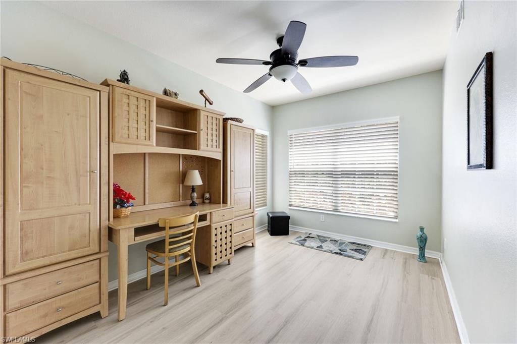 23861 Costa Del Sol Road, Unit 103 Estero, FL 34135 - Photo 7 of 29 a living room with furniture a ceiling fan and a window