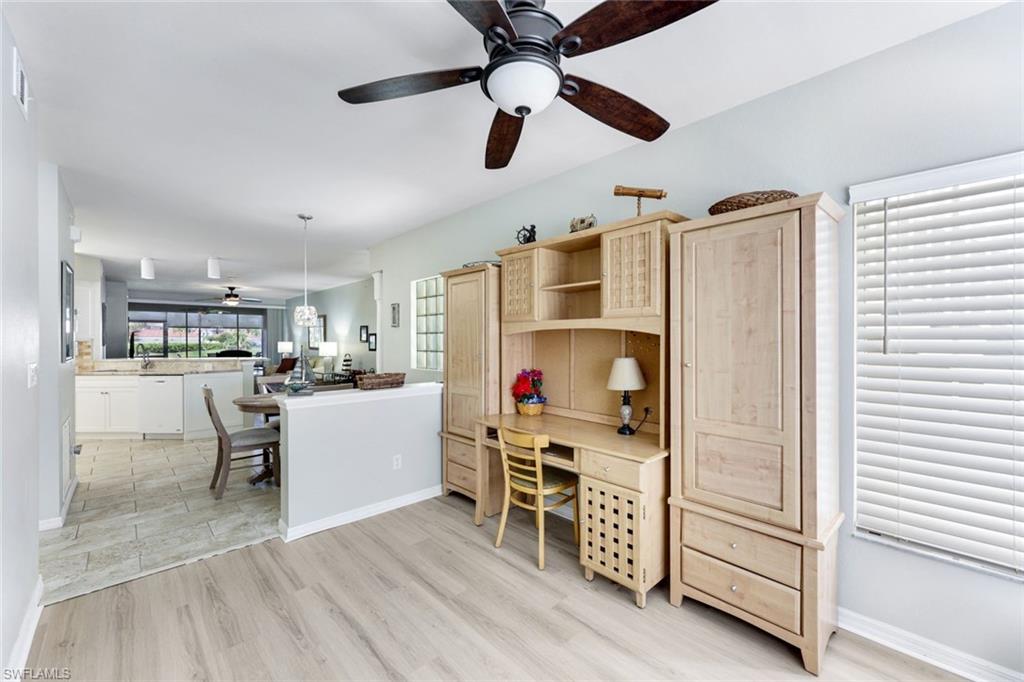 23861 Costa Del Sol Road, Unit 103 Estero, FL 34135 - Photo 8 of 29 a living room with furniture and a flat screen tv