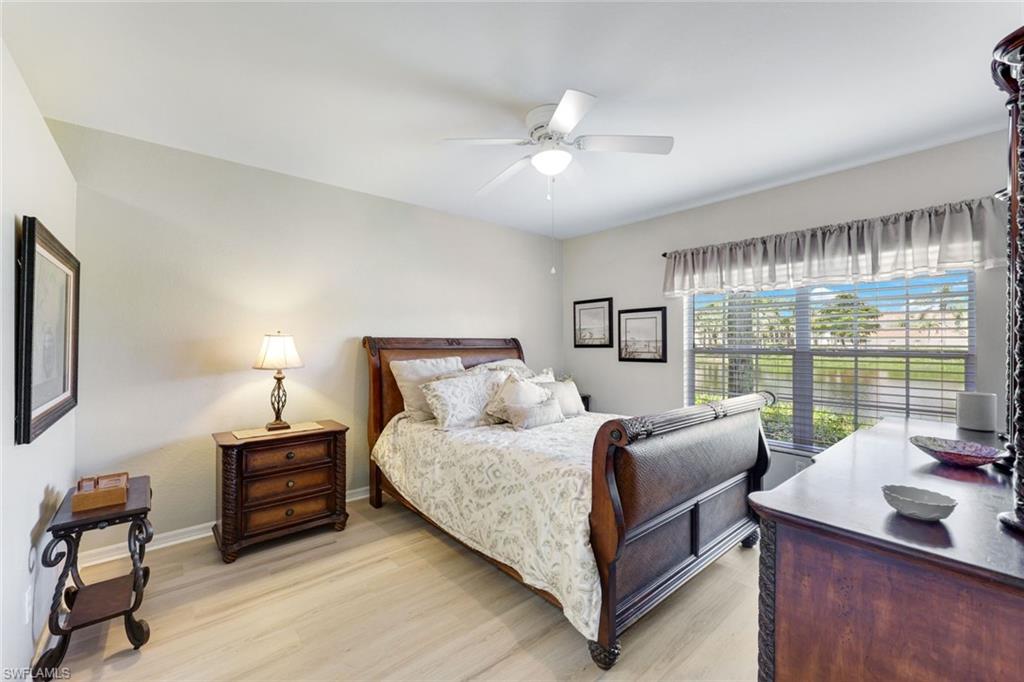 23861 Costa Del Sol Road, Unit 103 Estero, FL 34135 - Photo 9 of 29 a bedroom with a bed and a large window