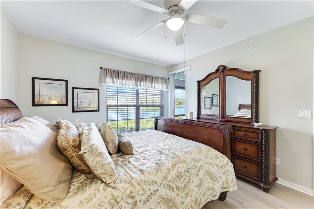 23861 Costa Del Sol Road, Unit 103 Estero, FL 34135 - Photo 10 of 29 a bedroom with a large bed and a large window