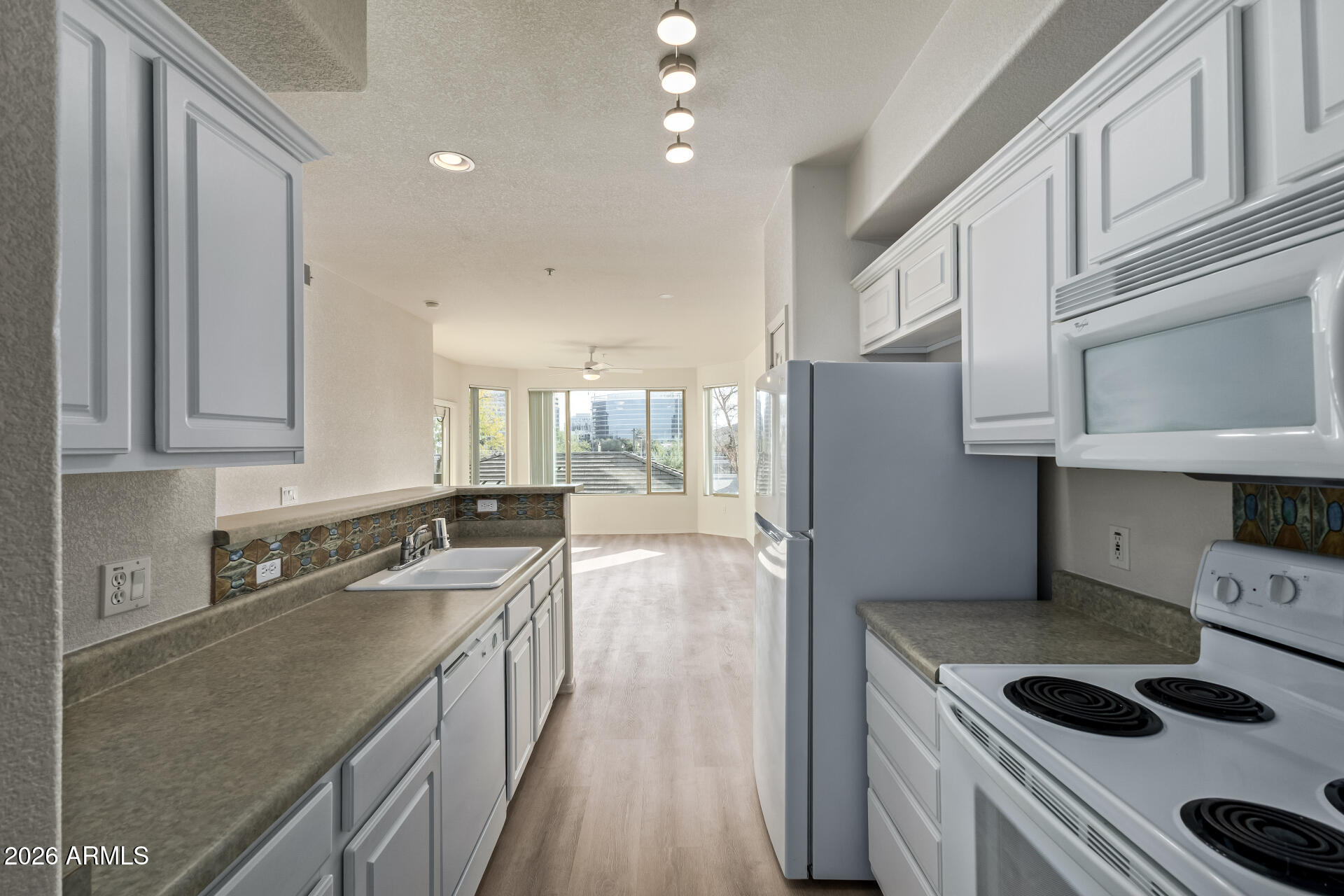 435 West Rio Salado Parkway, Unit 210 Tempe, AZ 85281 - Photo 11 of 35 a kitchen with stainless steel appliances granite countertop a sink stove and refrigerator